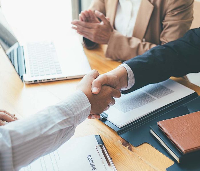 Successful businessmen handshaking after good deal. Business handshake and business people.